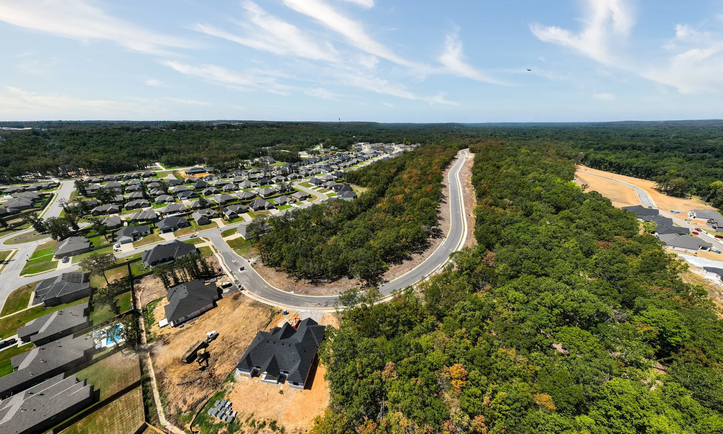 Aerial view of the Miller’s Ridge area, with homes, winding roads, and wooded land